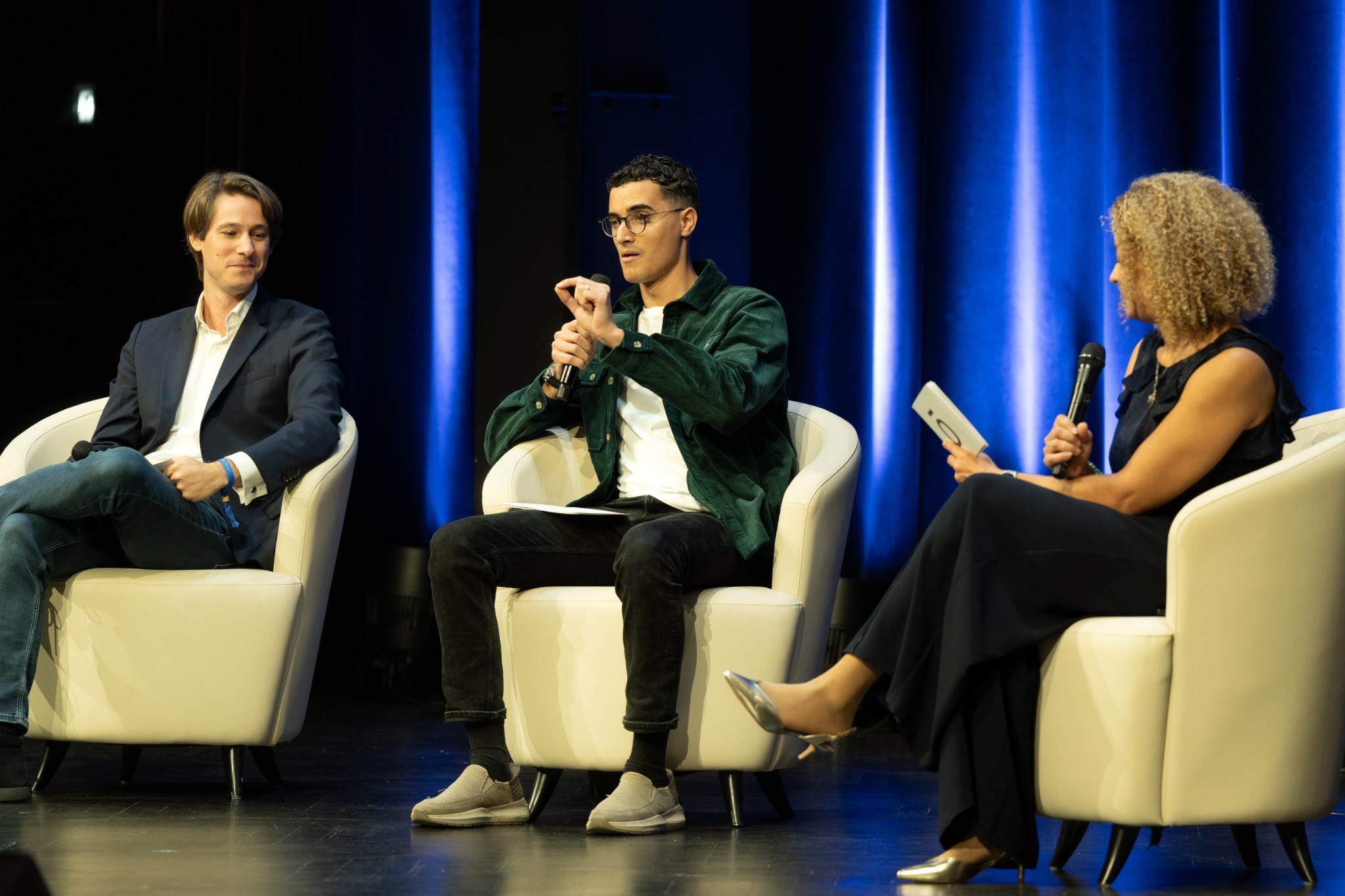 Panel discussion with a speaker holding a microphone