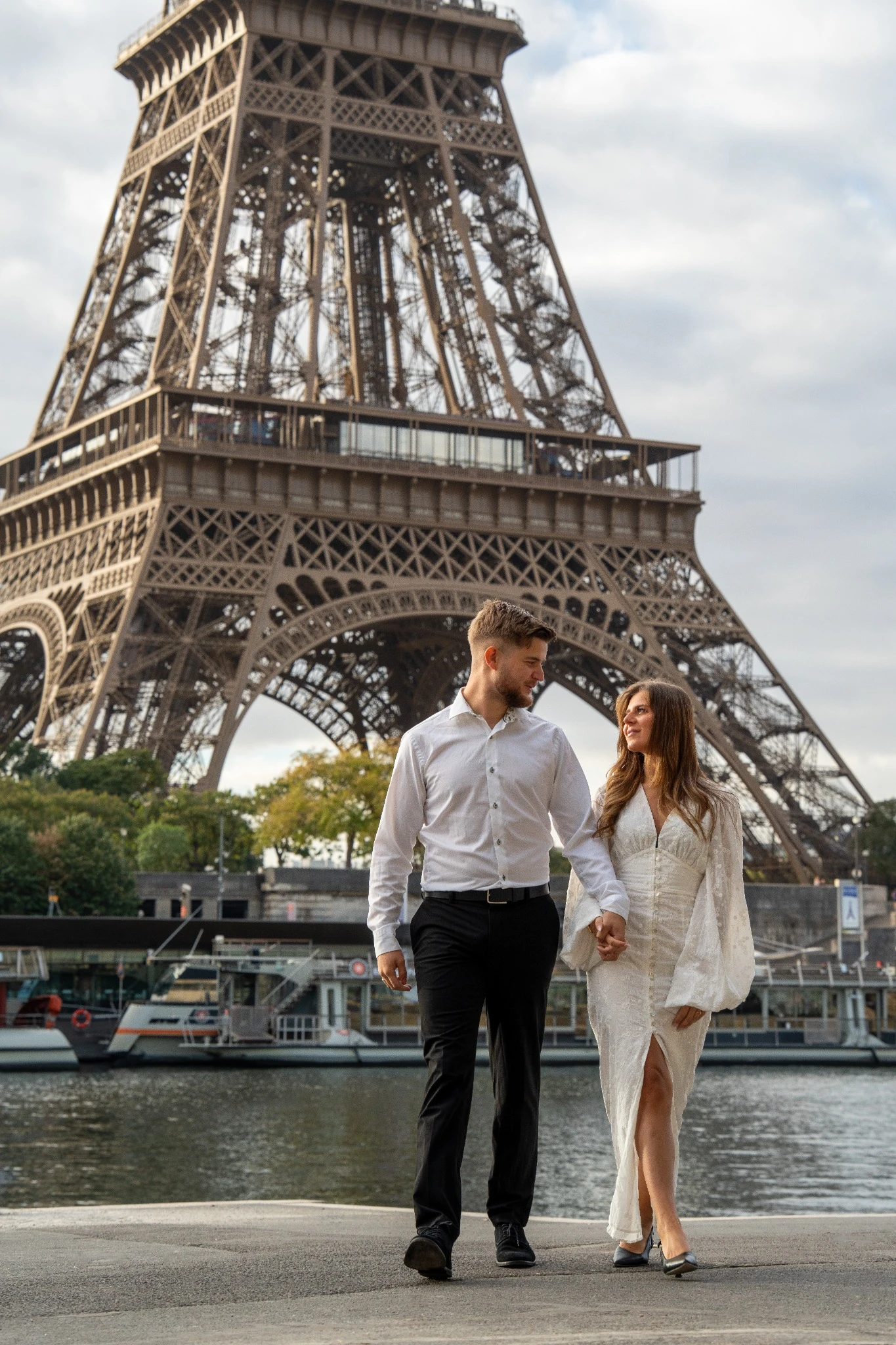 Couple walking beneath the Eiffel Tower in Paris
